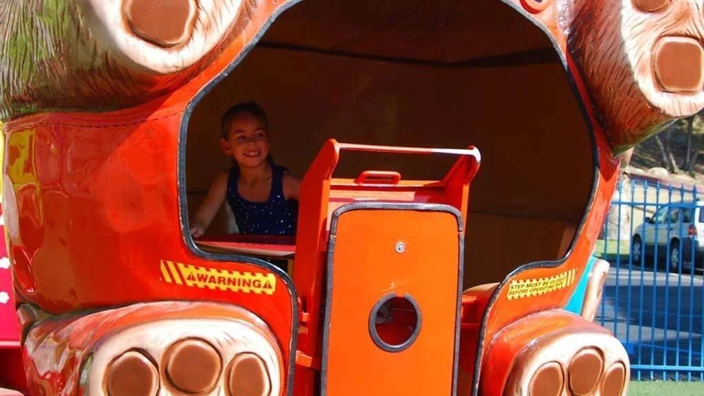Child on a kiddie ride at Fiesta Village Child on a kiddie ride at Fiesta Village