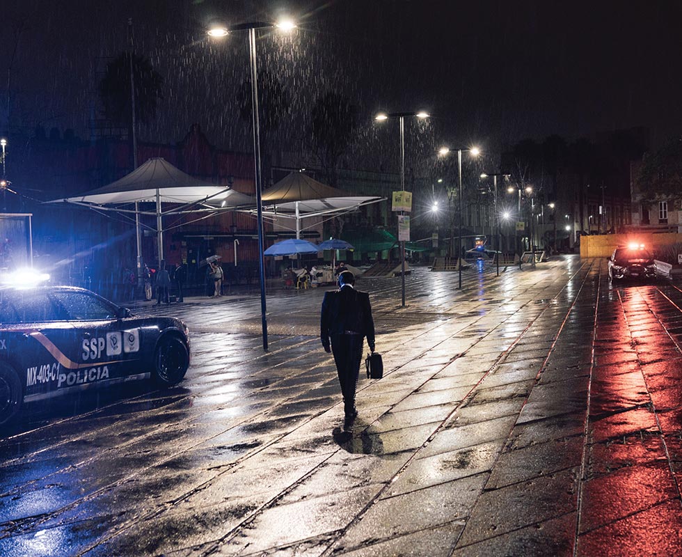 Exhausted from waiting for customers in the rain-soaked Plaza Garibaldi, a musician heads home. Before the COVID-19 pandemic, the music of the mariachis and the cheers of the crowd mingled here every evening.