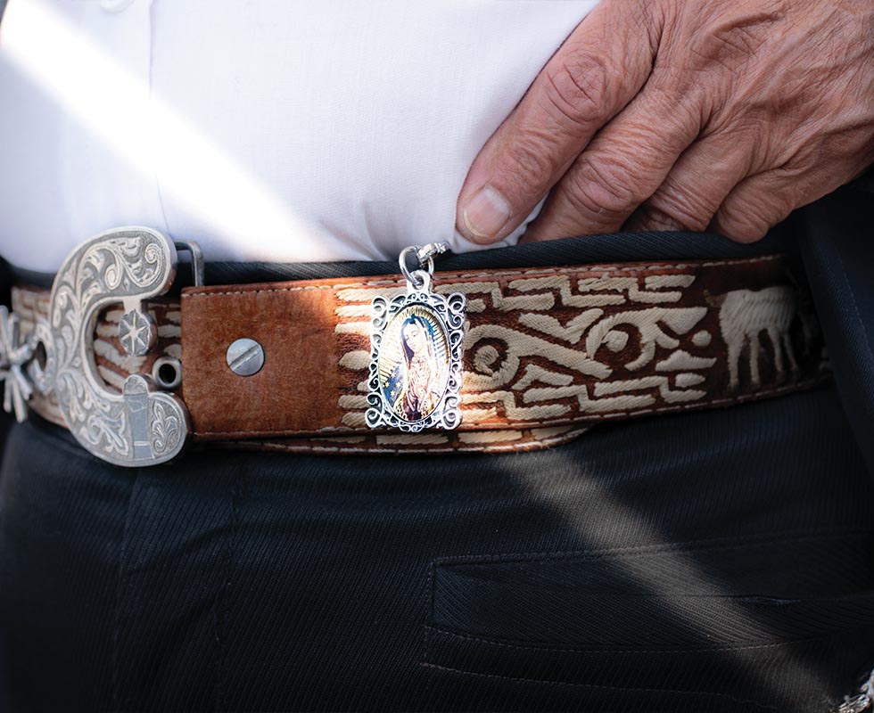 A mariachi musician met in Plaza Garibaldi wears a belt decorated with an image of the Virgin of Guadalupe, the ‘Patroness of the Americas’ and a symbol of Mexico.