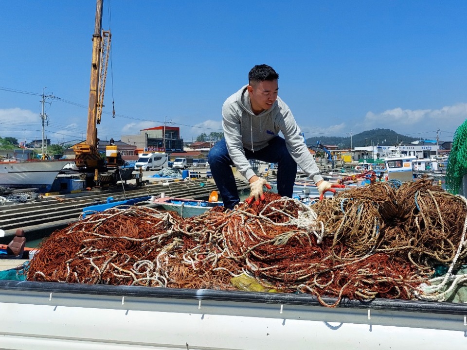 Small Action collecting discarded fishing nets